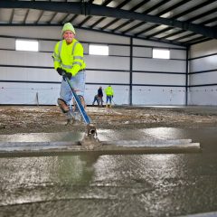man with stache working with concrete